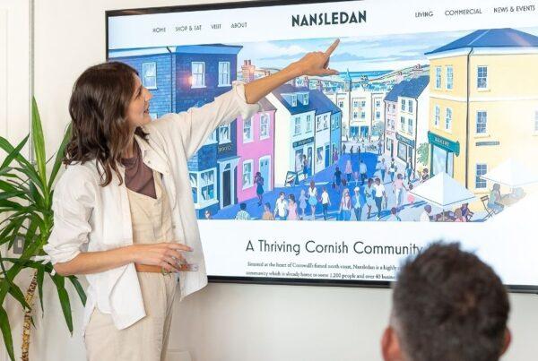 Accessibility in UX Design: What is it & Why is it Important? 2 Accessibility in UX - A designer pointing at the font on a website homepage