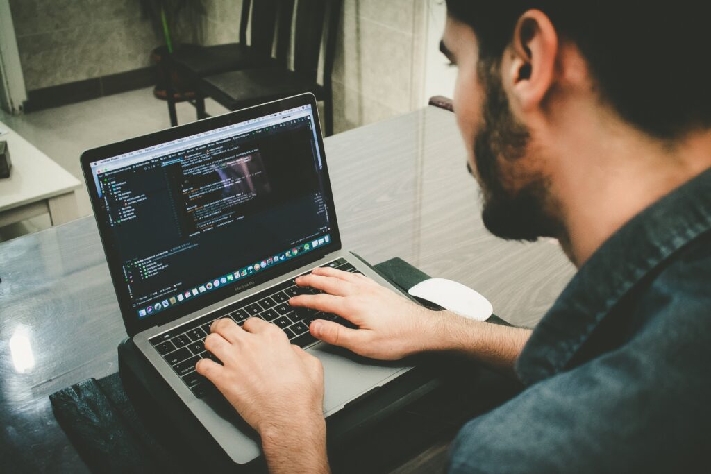 Man on computer coding 